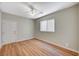 Bedroom featuring wood-look floors, neutral paint, and ample natural light at 10198 Timber Willow Ave, Las Vegas, NV 89135