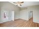 Bedroom showcasing wood-look floors, neutral paint, high ceilings, and multiple doorways at 10198 Timber Willow Ave, Las Vegas, NV 89135