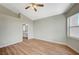 Bedroom featuring wood-look floors, neutral paint, high ceilings, and backyard views at 10198 Timber Willow Ave, Las Vegas, NV 89135