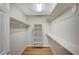 Walk-in closet featuring shelving and rod storage, plus wood-look floors at 10198 Timber Willow Ave, Las Vegas, NV 89135