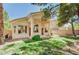 This is a view of the back of the house with landscaping and an arched covered patio at 10198 Timber Willow Ave, Las Vegas, NV 89135