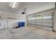 Spacious garage with an automatic door, shelving, and ample room for vehicles and storage at 10198 Timber Willow Ave, Las Vegas, NV 89135