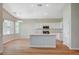 Kitchen features an island with a sink, stainless steel appliances, and ample natural light from the nearby windows at 10198 Timber Willow Ave, Las Vegas, NV 89135