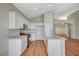 Well-lit kitchen featuring white cabinetry, stainless steel appliances, and an island with a sink at 10198 Timber Willow Ave, Las Vegas, NV 89135