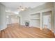 Bright living room showcasing a fireplace, built-in shelves, and wood-look flooring throughout the open floor plan at 10198 Timber Willow Ave, Las Vegas, NV 89135