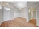 Spacious living room featuring wood floors, high ceilings, and stylish lighting, leading to the entry door at 10198 Timber Willow Ave, Las Vegas, NV 89135