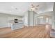 Open concept living space features vaulted ceilings, wood-look flooring, and a kitchen with an island and white cabinetry at 10198 Timber Willow Ave, Las Vegas, NV 89135