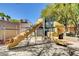 Brightly colored community playground with slides and climbing structures in a sand area at 10198 Timber Willow Ave, Las Vegas, NV 89135