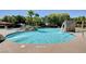 Resort-style pool with a slide, rock waterfall, and clear blue water, perfect for summer fun at 10198 Timber Willow Ave, Las Vegas, NV 89135