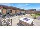 Backyard features a covered patio, cozy seating area, a fire pit, and low-maintenance desert landscaping at 10904 Ellis Pointe Ave, Las Vegas, NV 89166