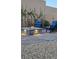 Beautiful stone fire pit with outdoor seating is surrounded by desert landscaping at 10904 Ellis Pointe Ave, Las Vegas, NV 89166
