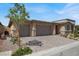 Charming home showcasing a three-car garage and well-maintained front yard with lush landscaping and beautiful hardscape at 10904 Ellis Pointe Ave, Las Vegas, NV 89166