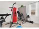 Home gym with a punching bag, fitness equipment, and a window, creating a dedicated space for health and wellness activities at 10904 Ellis Pointe Ave, Las Vegas, NV 89166
