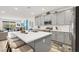 A gourmet kitchen featuring a spacious island with seating, modern appliances, and gray cabinets, ideal for culinary enthusiasts at 10904 Ellis Pointe Ave, Las Vegas, NV 89166