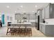A well-lit kitchen with a central island, stainless steel appliances, and gray cabinets, blending functionality and style seamlessly at 10904 Ellis Pointe Ave, Las Vegas, NV 89166
