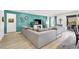 Bright living room with a large sectional sofa and access to an outdoor patio at 10904 Ellis Pointe Ave, Las Vegas, NV 89166
