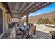 Covered patio with outdoor dining set, lounge chairs, and a fire pit for outdoor entertaining at 10904 Ellis Pointe Ave, Las Vegas, NV 89166