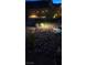 Night view of backyard putting green with artificial turf, surrounded by rock landscaping at 10904 Ellis Pointe Ave, Las Vegas, NV 89166