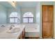 Bathroom featuring tile countertop, bathtub, and cabinet at 117 Lotus Blossom Ct, Las Vegas, NV 89145