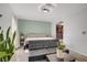 Bright bedroom featuring a bed, sofa, modern lighting, and a mirrored closet at 117 Lotus Blossom Ct, Las Vegas, NV 89145