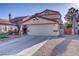 Charming home featuring a two-car garage, tile roof, desert landscaping, and a private courtyard entrance at 117 Lotus Blossom Ct, Las Vegas, NV 89145