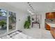 Modern kitchen with stainless steel appliances, updated cabinets, backsplash, island, and a sliding glass door at 117 Lotus Blossom Ct, Las Vegas, NV 89145