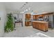 Modern kitchen with stainless steel appliances, updated cabinets, backsplash, island, and adjacent dining area at 117 Lotus Blossom Ct, Las Vegas, NV 89145