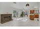 Bright living room with marble floors, a fireplace, sliding glass door to the backyard, and an open layout at 117 Lotus Blossom Ct, Las Vegas, NV 89145
