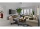 Comfortable living room with modern furnishings, large windows, and neutral color palette. (Virtually Staged) at 117 Lotus Blossom Ct, Las Vegas, NV 89145