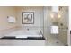 Bright bathroom with a shower, a bathtub and a tile surround, creating a spa-like experience at 135 E Harmon Ave # 2116, Las Vegas, NV 89109