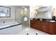 Bright bathroom with a shower, a tub, double sinks, and a vanity, creating a luxurious spa-like experience at 135 E Harmon Ave # 2116, Las Vegas, NV 89109