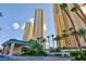 Exterior view showcases the building's entrance and lush landscaping at 135 E Harmon Ave # 2116, Las Vegas, NV 89109