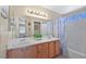 Bathroom with a blue and white shower curtain, dual sinks and a large mirror at 1405 Bugle Boy Dr, Henderson, NV 89014