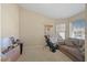 Versatile bonus room with a sofa and two windows offering plenty of natural light at 1405 Bugle Boy Dr, Henderson, NV 89014