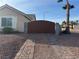 Gated driveway with brick pavers and desert landscaping at 1405 Bugle Boy Dr, Henderson, NV 89014