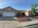 Charming single-story home with a well-maintained front yard and two-car garage at 1405 Bugle Boy Dr, Henderson, NV 89014
