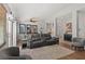 Spacious living room featuring modern furniture, a ceiling fan, and neutral decor at 1405 Bugle Boy Dr, Henderson, NV 89014
