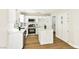 Well-lit kitchen with white cabinets, an island, and stainless steel appliances at 1724 Navajo Lake Way, Las Vegas, NV 89128