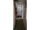 Hallway with carpeted floors, neutral walls, and access to various rooms at 1886 Ludington Ave, Las Vegas, NV 89156