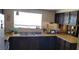 Functional kitchen featuring dark wood cabinets, a double sink, and natural light at 1886 Ludington Ave, Las Vegas, NV 89156