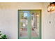 Exterior shot of the front door with green trim and ambient outdoor lighting at 1905 Plaza Del Padre, Las Vegas, NV 89102