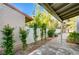 Landscaped backyard featuring a covered patio and mature shrubbery for privacy at 1905 Plaza Del Padre, Las Vegas, NV 89102
