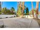 Backyard patio area with mature trees providing privacy and shade at 1905 Plaza Del Padre, Las Vegas, NV 89102