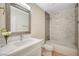 Bathroom with quartz countertop, decorative mirror, and tiled shower and tub at 1905 Plaza Del Padre, Las Vegas, NV 89102
