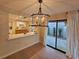 Well-lit dining area features a modern chandelier and sliding glass doors at 1905 Plaza Del Padre, Las Vegas, NV 89102