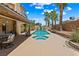 Inviting backyard with a pool, palm trees, and a covered patio seating area at 2042 Maple Springs St, Henderson, NV 89002