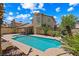 Backyard featuring a pool, palm trees, and a covered patio at 2042 Maple Springs St, Henderson, NV 89002