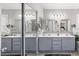 Bright bathroom with dual sinks, modern lighting, and large mirrors for added space at 2042 Maple Springs St, Henderson, NV 89002