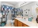 Well-lit bathroom with a patterned shower curtain, vanity, and sink at 2042 Maple Springs St, Henderson, NV 89002