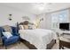 Comfortable bedroom with a decorative wall piece, ceiling fan, and large window at 2042 Maple Springs St, Henderson, NV 89002